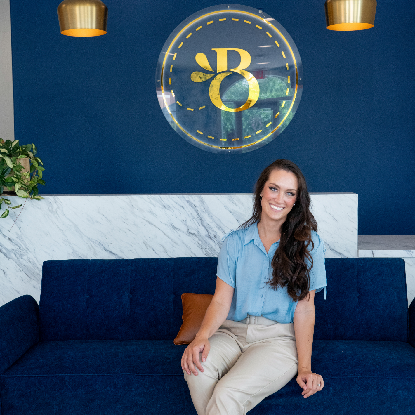 Benbrook orthodontist Doctor Lena Bortnem sitting on a dark blue couch.